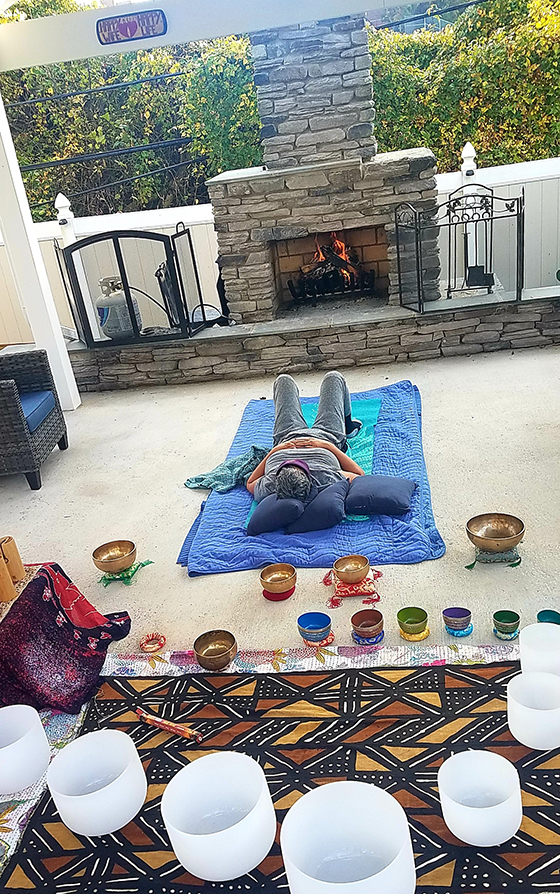 Client reclines in her gazebo for an early morning sound bath